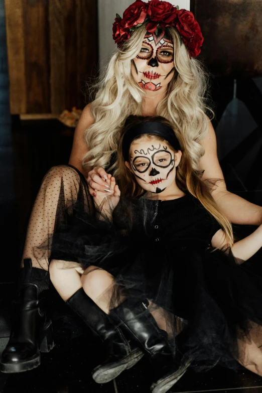 a woman sitting next to a little girl in a black dress, skull face paint, flatlay, square, 2995599206
