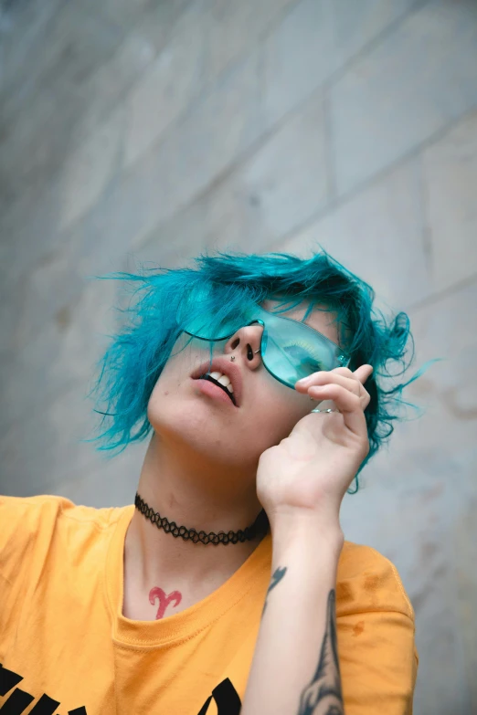 a woman with blue hair talking on a cell phone, inspired by Elsa Bleda, trending on pexels, wearing shades, looking upward, lesbians, profile pic