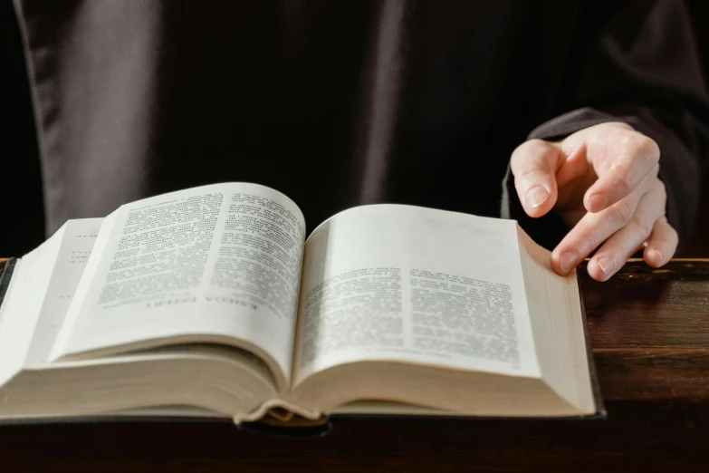 a close up of a person holding an open book, cleric, instagram post, high resolution, thumbnail