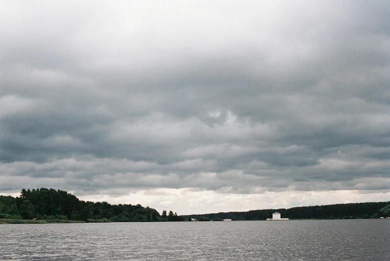 a large body of water under a cloudy sky, by Grytė Pintukaitė, water reservoir, midsummer, museum photo