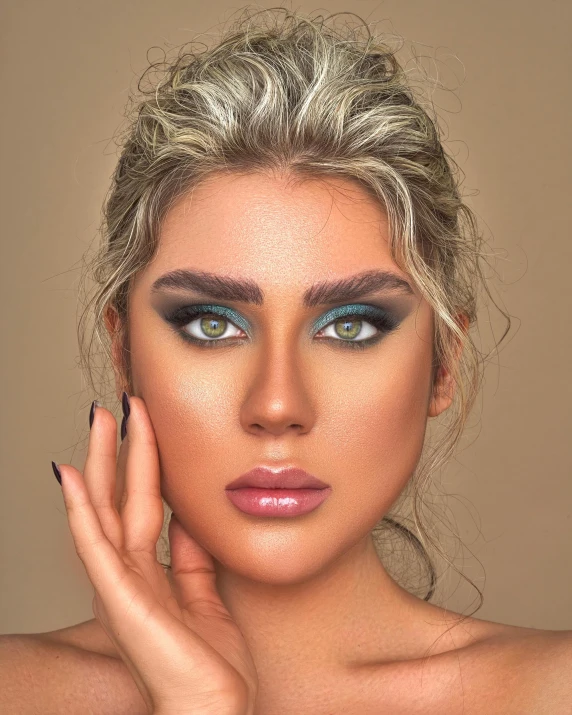 a woman is posing with her hands on her face, a colorized photo, inspired by Hedi Xandt, tanned ameera al taweel, ((greenish blue tones)), blonde hair and large eyes, dark green smokey eyeshadow