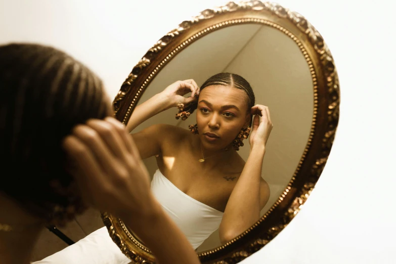 a woman brushing her hair in front of a mirror, pexels contest winner, renaissance, brown skinned, wearing pearl earrings, cracked mirror, low quality photograph