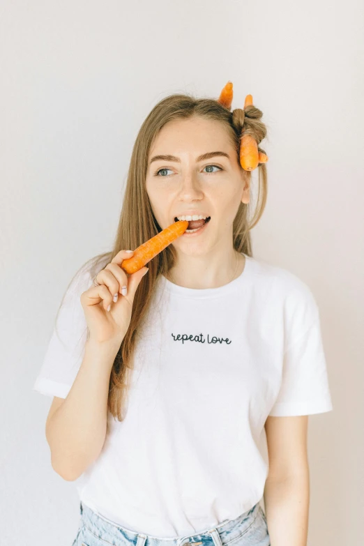 a woman holding a carrot in her mouth, inspired by Yerkaland, unsplash, wearing a t-shirt, styled hair, product image, really long