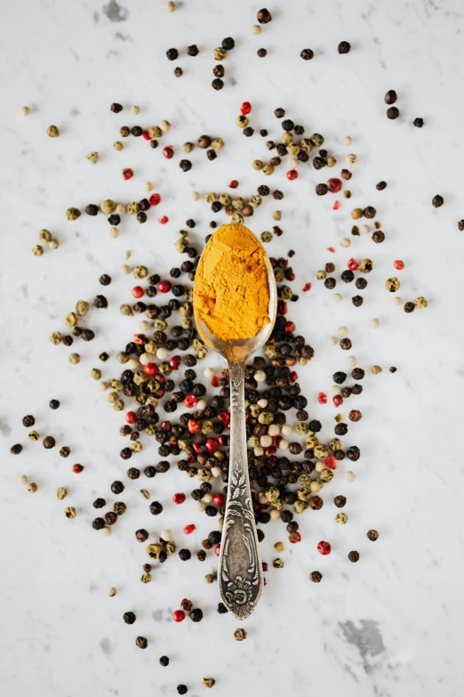 a spoon filled with spices sitting on top of a table, trending on pexels, renaissance, mustard, with sparkling gems on top, modern”, center frame medium shot