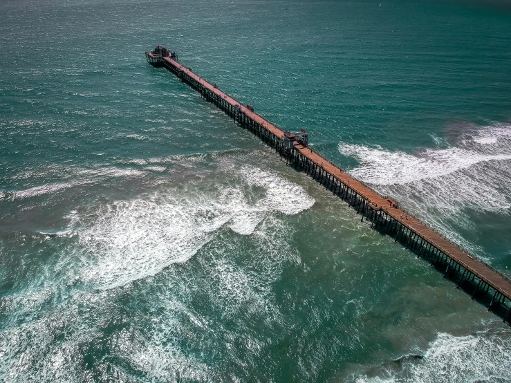 a long pier in the middle of the ocean, pexels contest winner, turbulent water, aerial footage, profile pic, puerto rico
