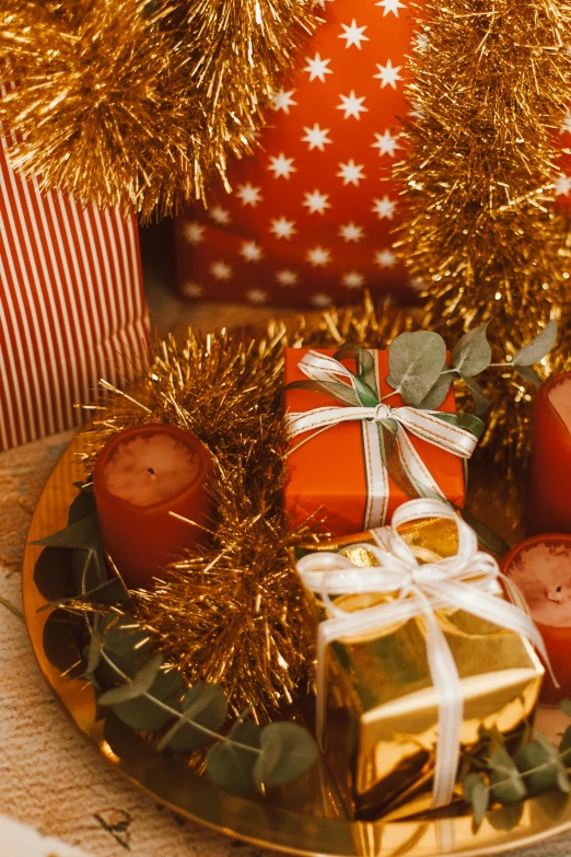 a close up of a plate of food on a table, gifts, red and gold, presents, evenly lit