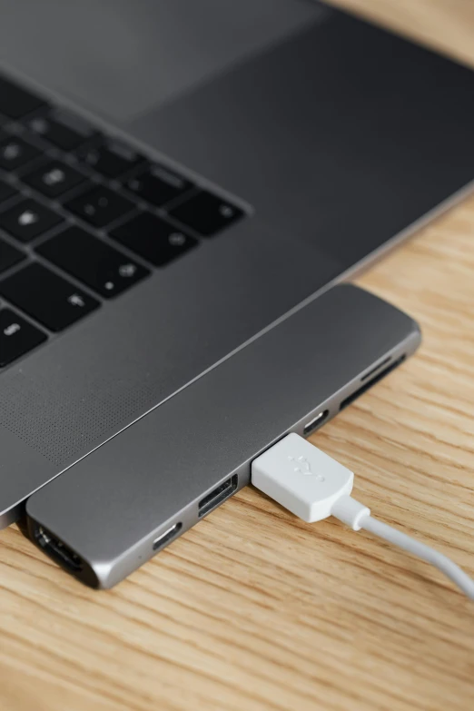 a laptop computer sitting on top of a wooden table, satisfying cable management, thumbnail, detailed product image