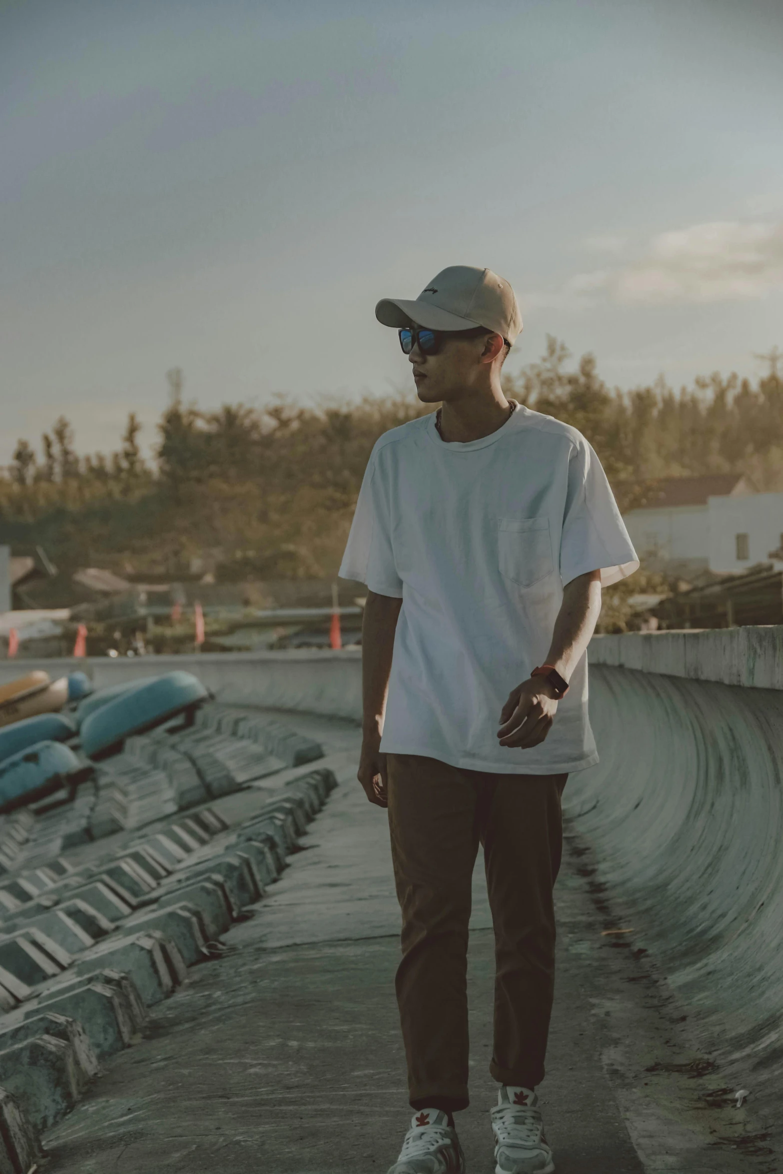 a man standing on top of a skateboard ramp, by Afewerk Tekle, unsplash contest winner, wearing sunglasses and a cap, wavy, very faded, looking off to the side