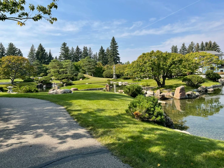 a park with a pond in the middle of it, inspired by Miyagawa Chōshun, unsplash, avatar image, vancouver, 2 0 2 2 photo, bright sunny summer day