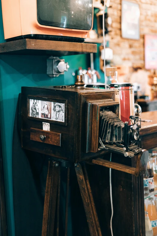 a television sitting on top of a wooden table, a polaroid photo, unsplash, art nouveau, vending machines, absinthe, steampunc, thumbnail