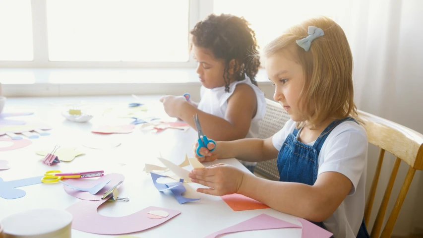 a group of children sitting at a table making crafts, trending on pexels, paper cut out, two girls, thumbnail, beautiful angle