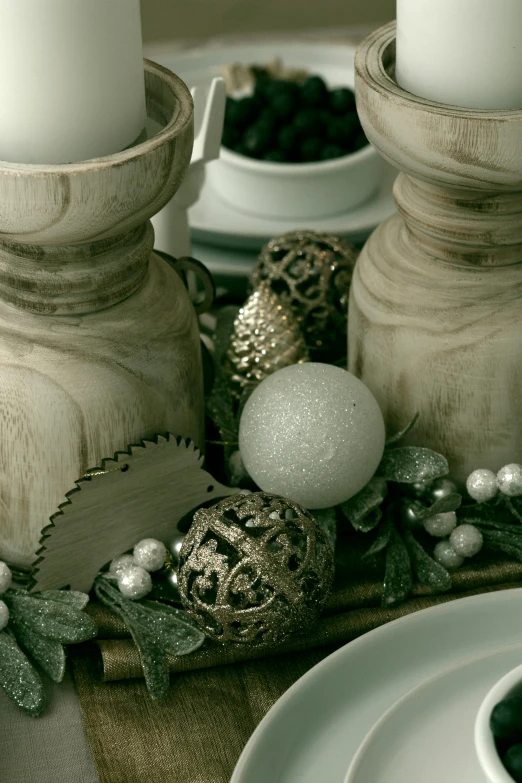 a couple of candles sitting on top of a table, with lots of thin ornaments, texture detail, pearlized, with detailed wood
