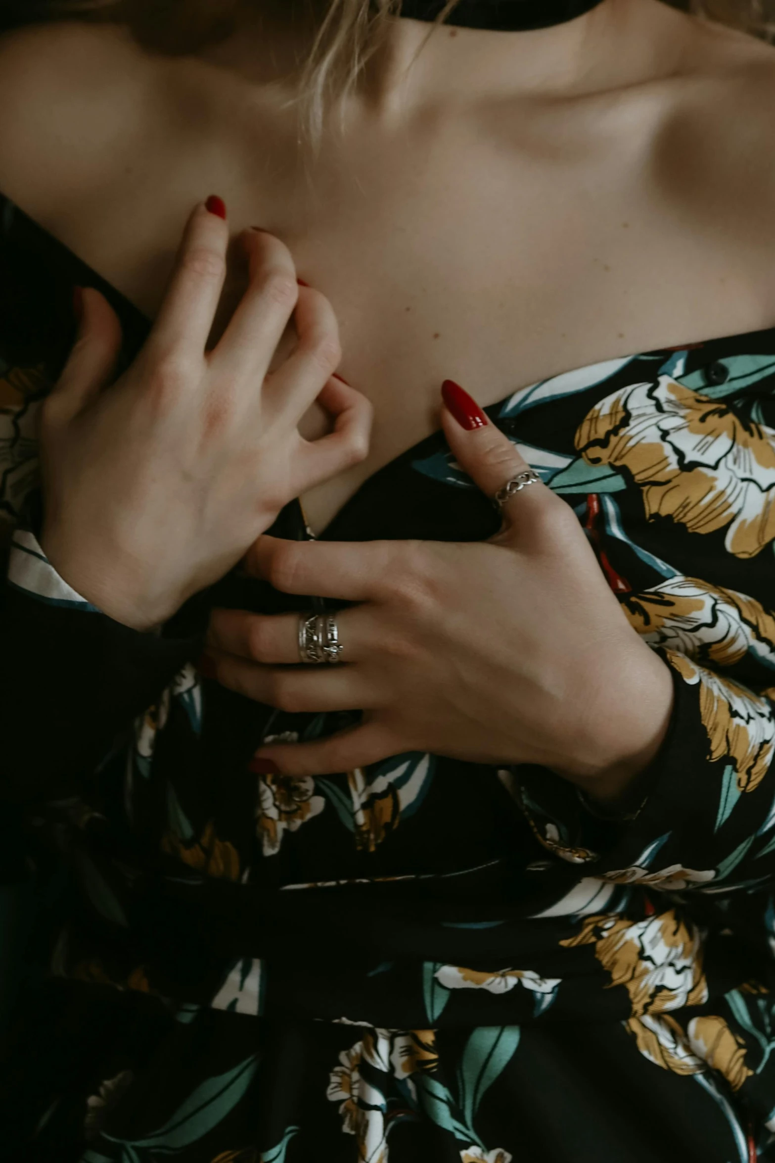 a woman in a floral dress posing for a picture, a tattoo, inspired by Elsa Bleda, trending on pexels, rings, wearing dark silk robe, 👅 👅, holding hands