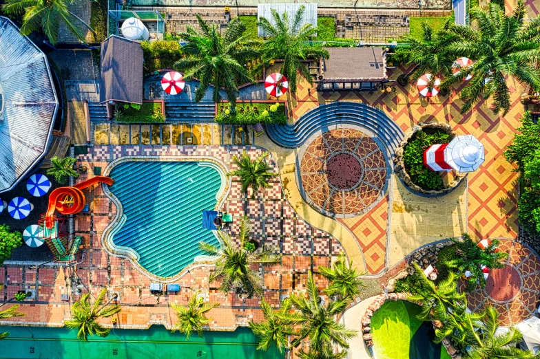 an aerial view of a swimming pool surrounded by palm trees, unsplash, naive art, fisher price public pool, listing image, holiday resort, well decorated