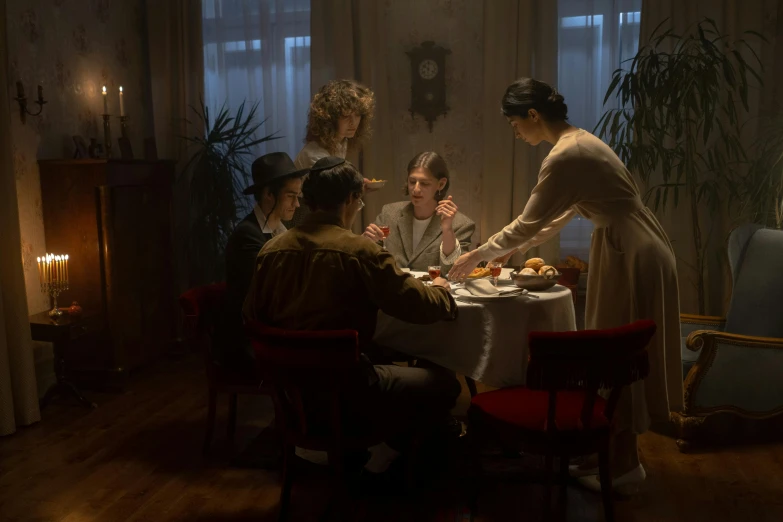 a group of people sitting around a dinner table, a portrait, by Else Alfelt, pexels contest winner, art nouveau, cinematic scene, set in ww2 germany, light behind, set photo in costume