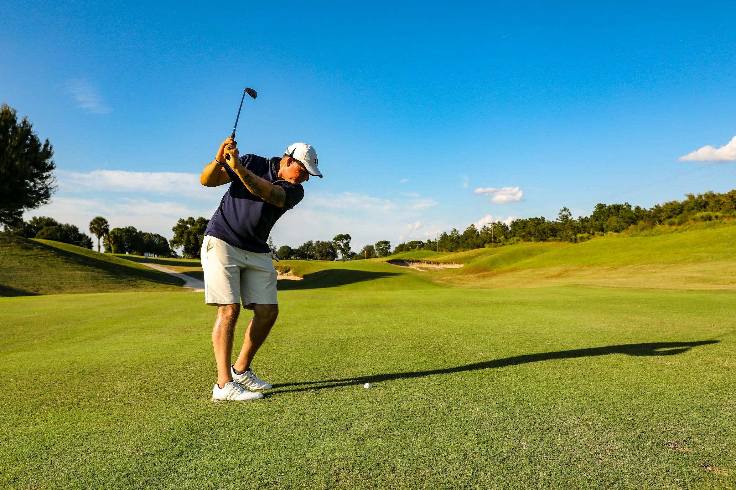 a man hitting a golf ball on a golf course, a portrait, pexels contest winner, avatar image, blue sky, profile image, thumbnail