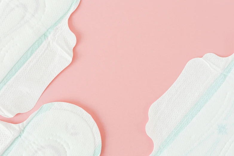 a pair of sanitary pads sitting on top of a pink surface, trending on pexels, arched back, thighs close up, pastelwave, white hue