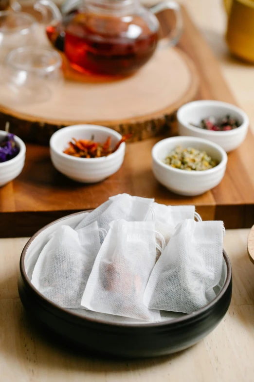 a close up of a plate of food on a table, teapots, dried herbs, 6 pack, cloth wraps