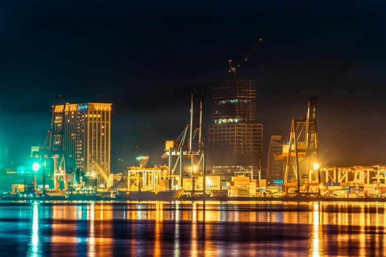 a large body of water with a city in the background, by Thomas Häfner, pexels contest winner, hurufiyya, with neon lights, oman, port scene background, thumbnail