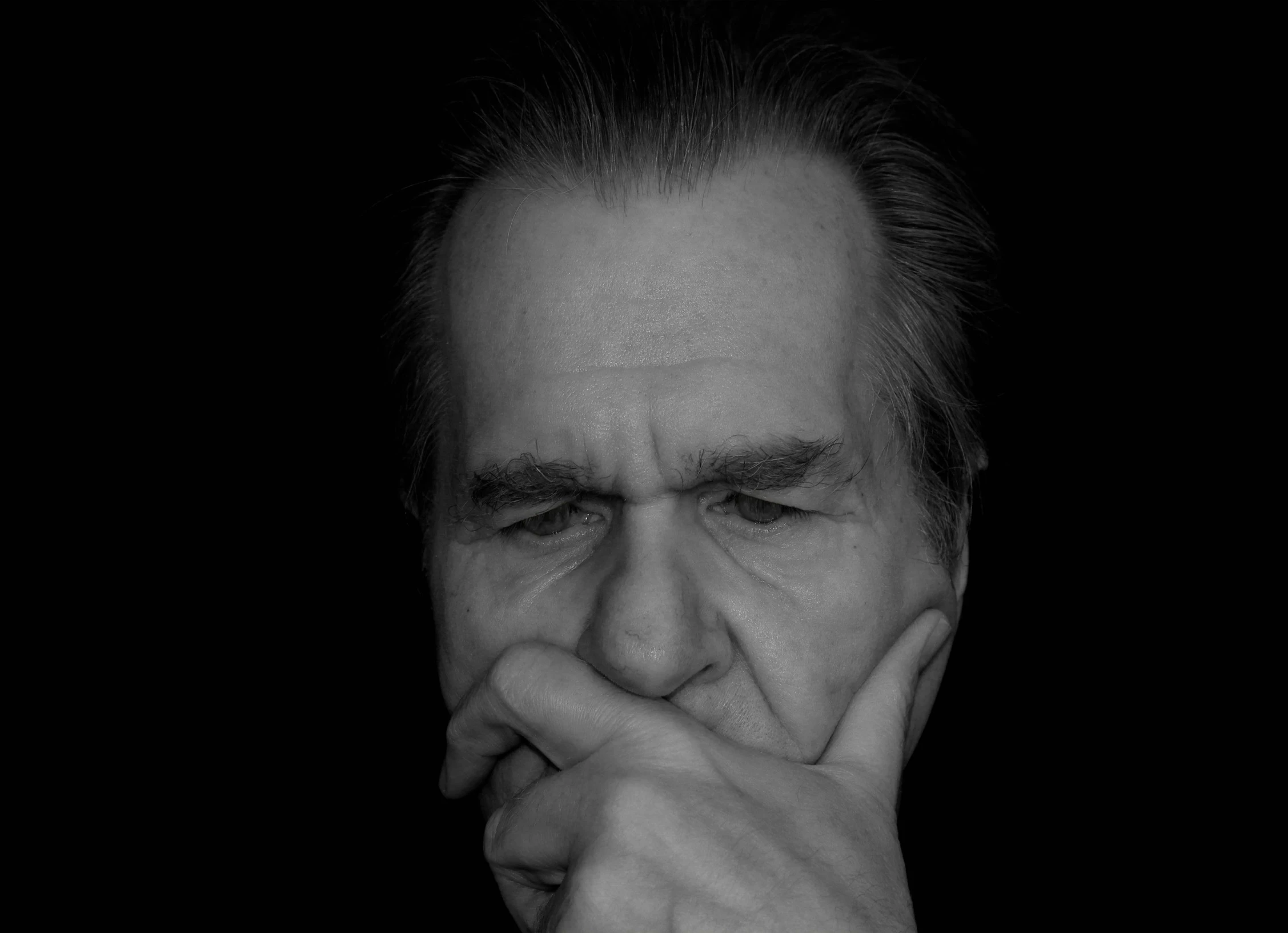 a black and white photo of a man with his hand on his chin, pixabay, visual art, richard nixon, dark grey haired man, hand over mouth, hr giger. 8 k