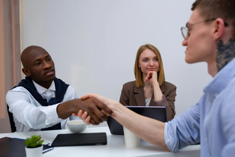 a group of people sitting around a table shaking hands, profile image, ignant, professional modeling, professional closeup photo