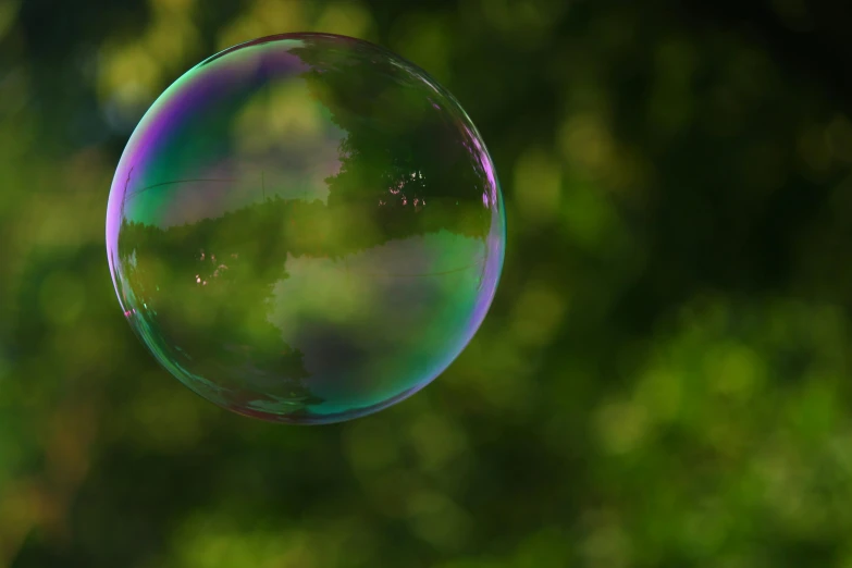 a soap bubble floating in the air with trees in the background, an elegant green, bubblegum