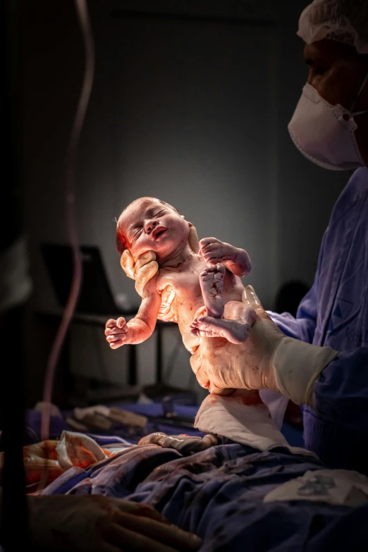 a close up of a person holding a baby, surgery theatre, beautifully lit, full frontal, contest winner 2021