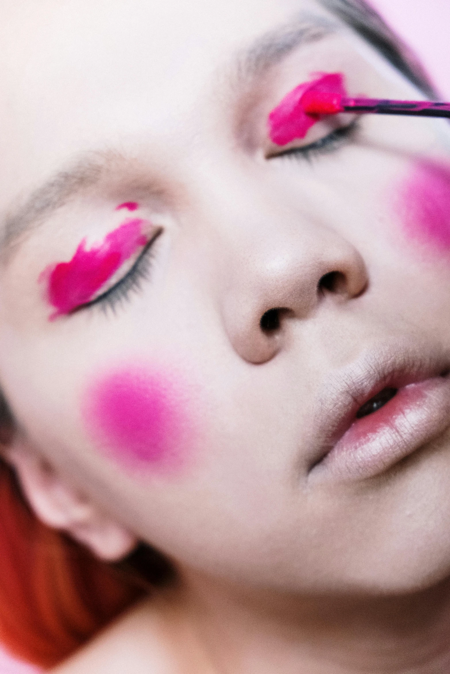 a woman is getting her make up done, an album cover, inspired by Taro Yamamoto, trending on pexels, aestheticism, hot pink, high angle close up shot, non binary model, fairy look