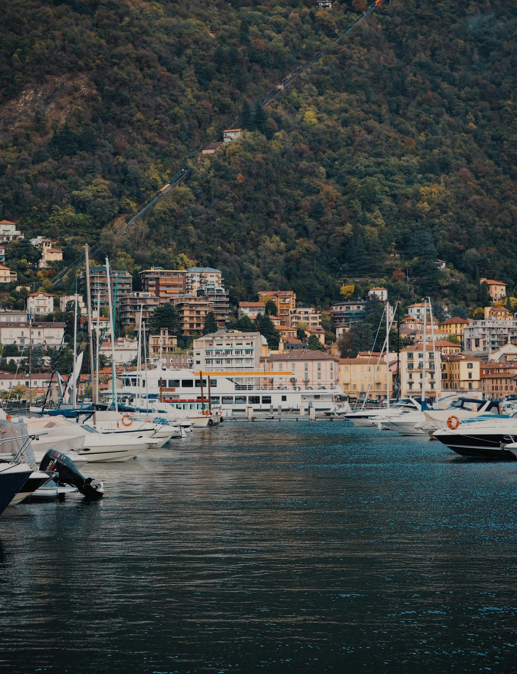 a number of boats in a body of water, by Carlo Martini, pexels contest winner, renaissance, with mountains as background, low quality photo, thumbnail, small city