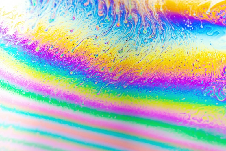 a close up of soap bubbles on a plate, a microscopic photo, inspired by Gabriel Dawe, unsplash, holography, rainbow stripe background, vaporwave textures, fluid lines, lsd feathers