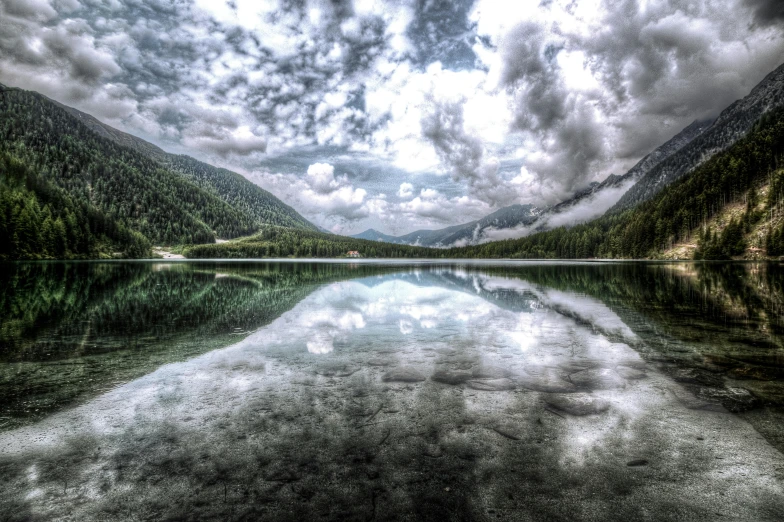 a lake surrounded by mountains under a cloudy sky, by Wolfgang Zelmer, pexels contest winner, hdr refractions, crystal clear, gray clouds, infinite intricacy