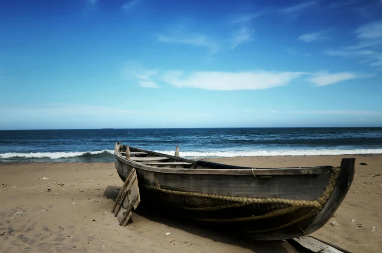 a boat sitting on top of a sandy beach, pexels contest winner, “ iron bark, south african coast, thumbnail, blue