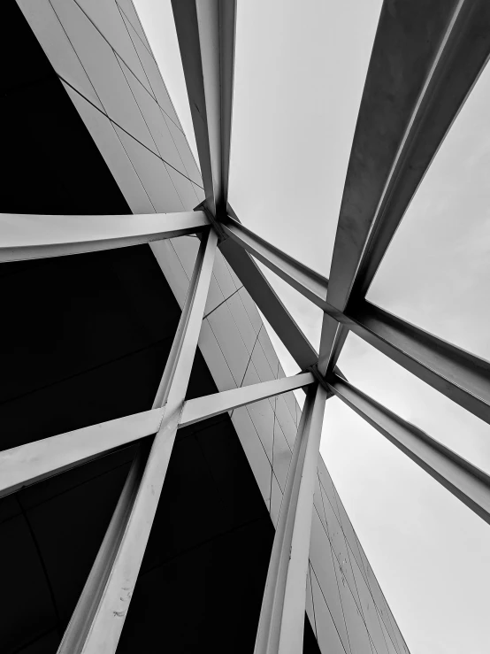 a black and white photo of the underside of a bridge, an abstract sculpture, by Jacob Toorenvliet, square lines, low angle!!!!, shot on iphone 6, windows and walls :5