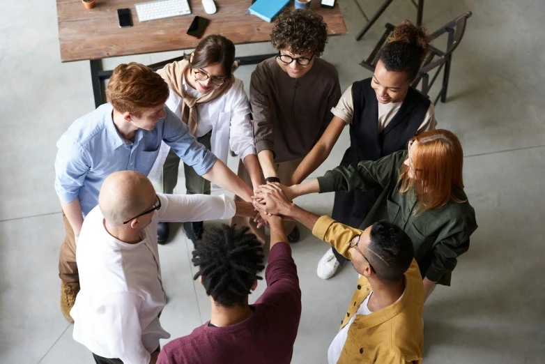 a group of people holding hands in a circle, by Nina Hamnett, trending on pexels, renaissance, standing on a desk, worksafe. instagram photo, te pae, ethnic group