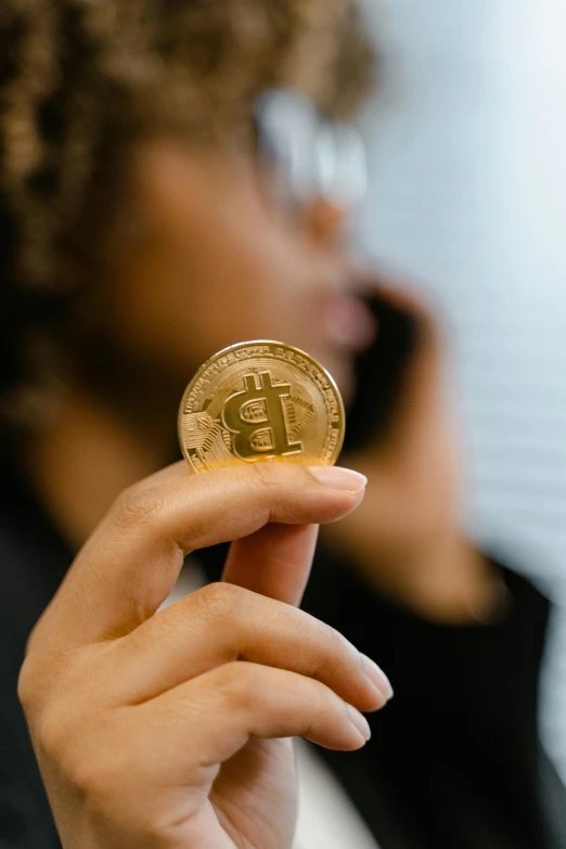 a woman talking on a cell phone while holding a bit coin, trending on unsplash, renaissance, low quality photo, inspect in inventory image, bitcoin, afro tech