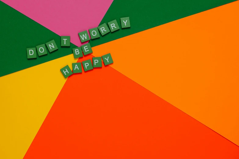 a colorful umbrella with the words don't worry be happy written on it, an album cover, inspired by Tom Wesselmann, a rubik's cube, matt mute colour background, bright green dark orange, colourful close up shot