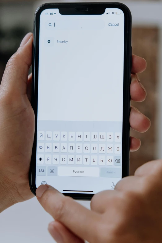 a close up of a person holding a cell phone, trending on pexels, subtitles, keyboard, white hue, ios