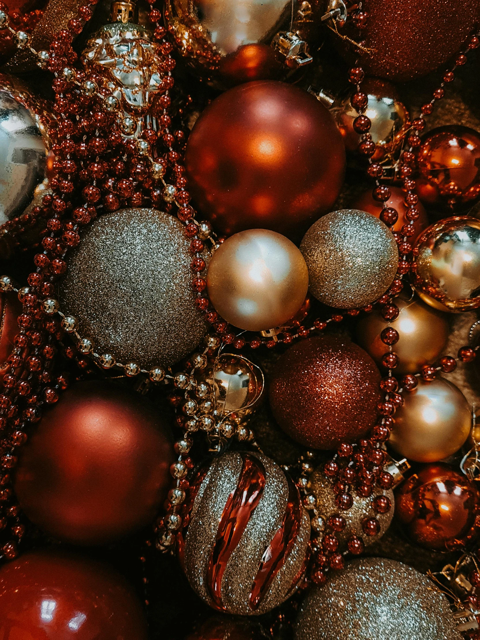 a pile of christmas ornaments sitting on top of a table, pexels, baroque, red and brown color scheme, premium, beads, instagram photo