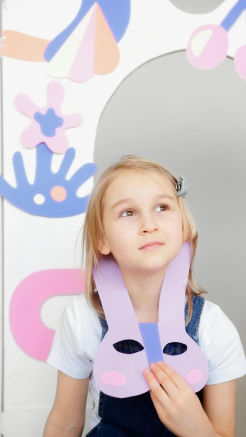 a girl holding a paper bunny mask in front of a mirror, a child's drawing, inspired by Annabel Eyres, pexels contest winner, 15081959 21121991 01012000 4k, wearing collar on neck, on a gray background, softplay