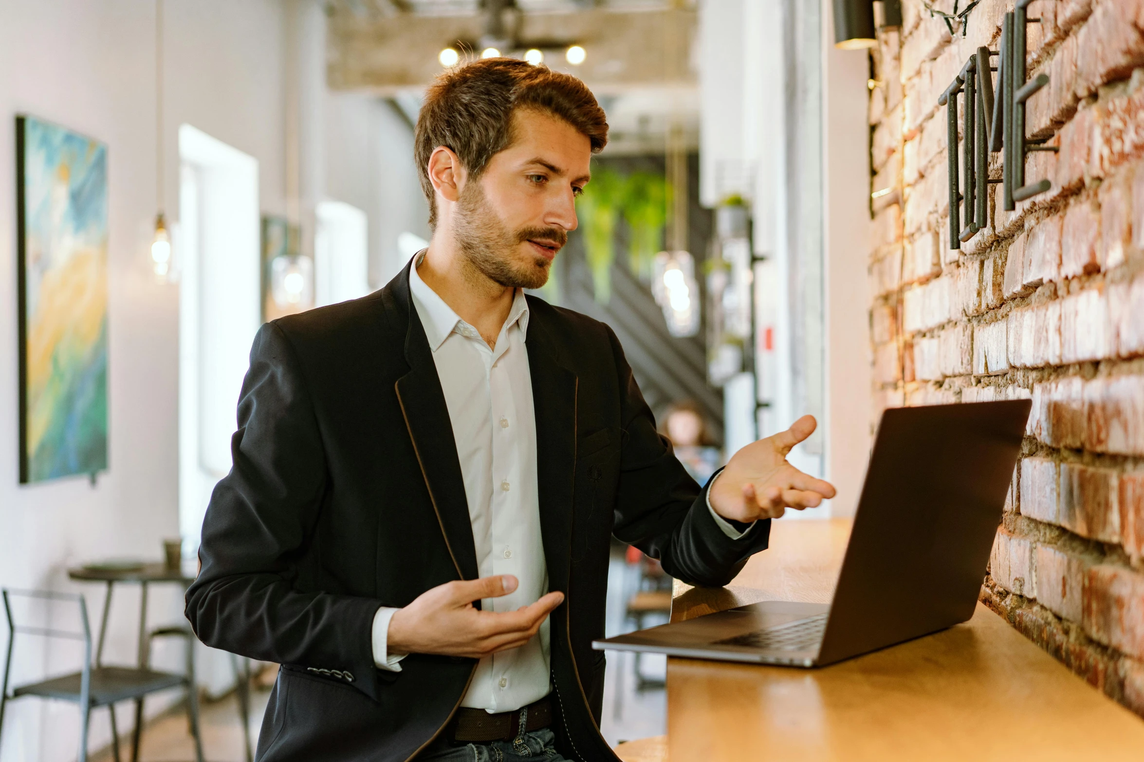 a man standing in front of a laptop computer, pexels contest winner, renaissance, wearing a blazer, hovering indecision, tech demo, presenting wares