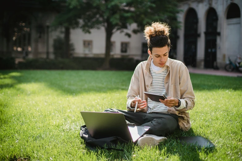 a woman sitting in the grass with a laptop and cell phone, pexels contest winner, academic art, university, people at work, avatar image, instagram post