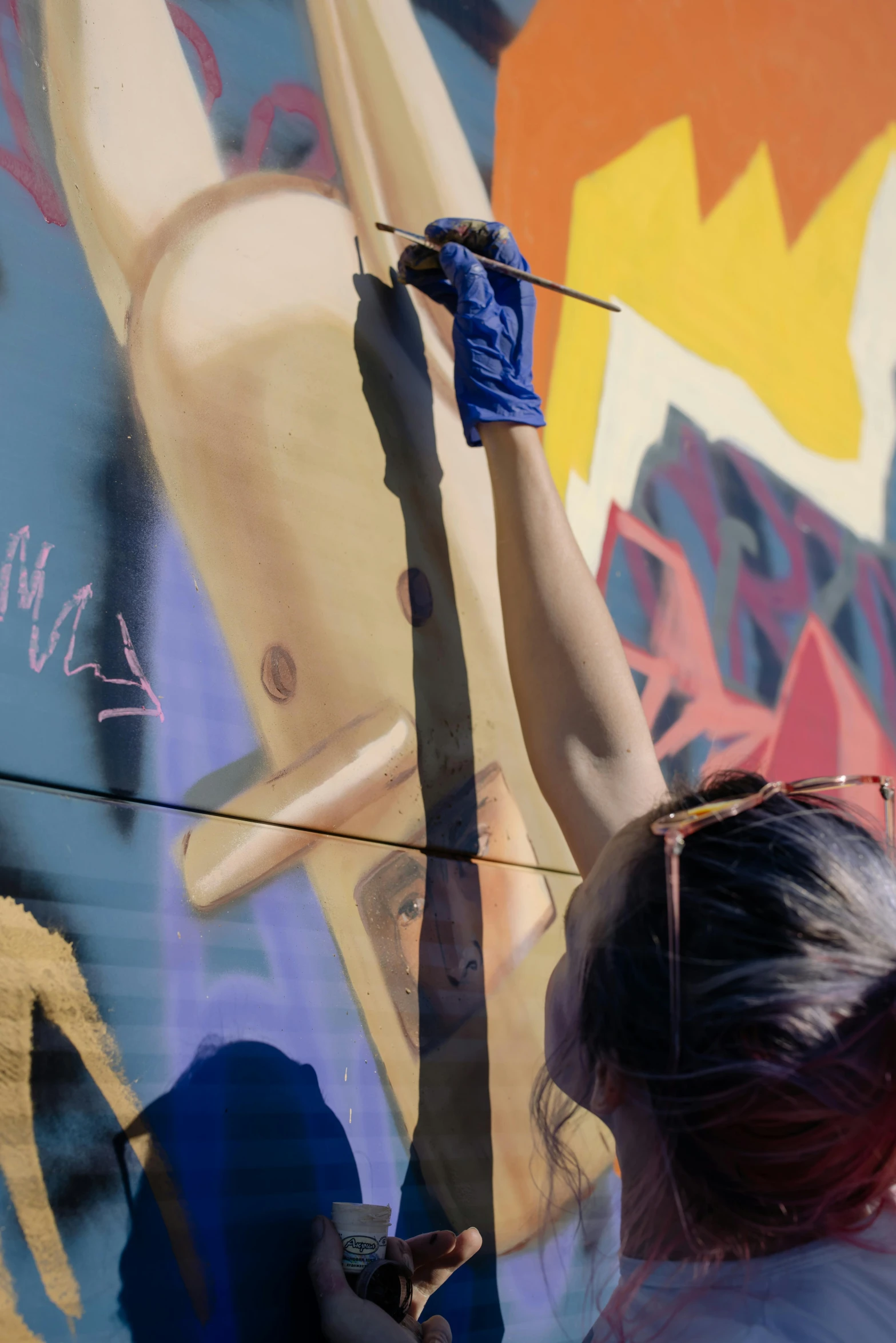 a woman painting a mural on the side of a building, by karlkka, pexels contest winner, graffiti, boris vallejo and ilya kuvshinov, medium shot close up, promo image, full color still