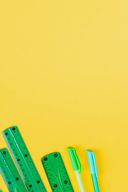 a group of school supplies on a yellow background, trending on pexels, conceptual art, #green, made of lego, zippers, u