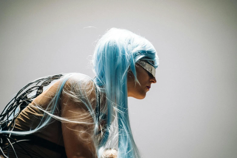 a woman with blue hair holding a teddy bear, inspired by Elsa Bleda, unsplash, hurufiyya, blindfold, futuristic fashion show, silver hair (ponytail), view from the side