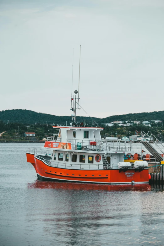 a boat that is sitting in the water, quebec, vibrant but dreary orange, astri lohne, grey