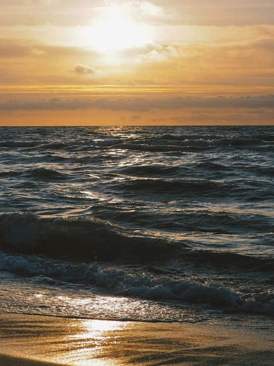 a man riding a surfboard on top of a sandy beach, by Niko Henrichon, pexels contest winner, romanticism, dappled golden sunset, photo of the middle of the ocean, calmly conversing 8k, album cover