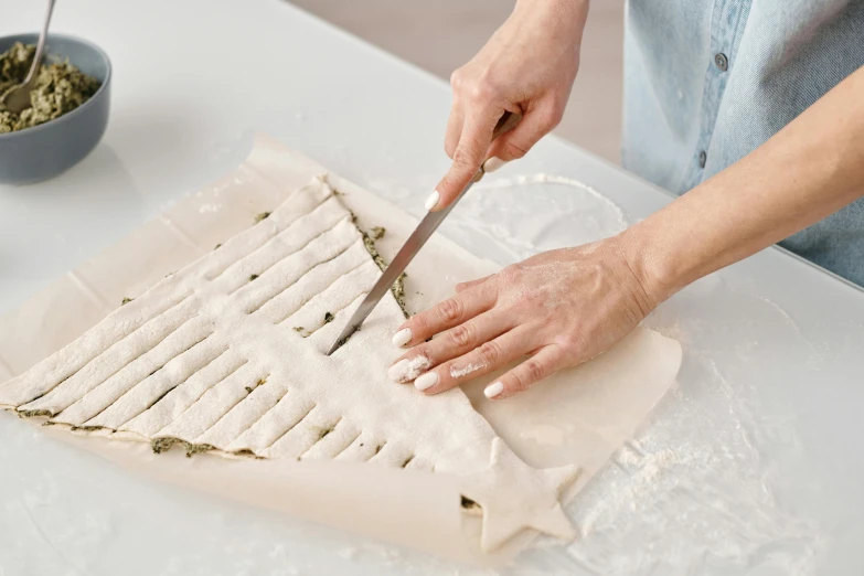 a close up of a person cutting food on a table, a marble sculpture, linen canvas, dried herbs, baking artwork, epicanthal fold