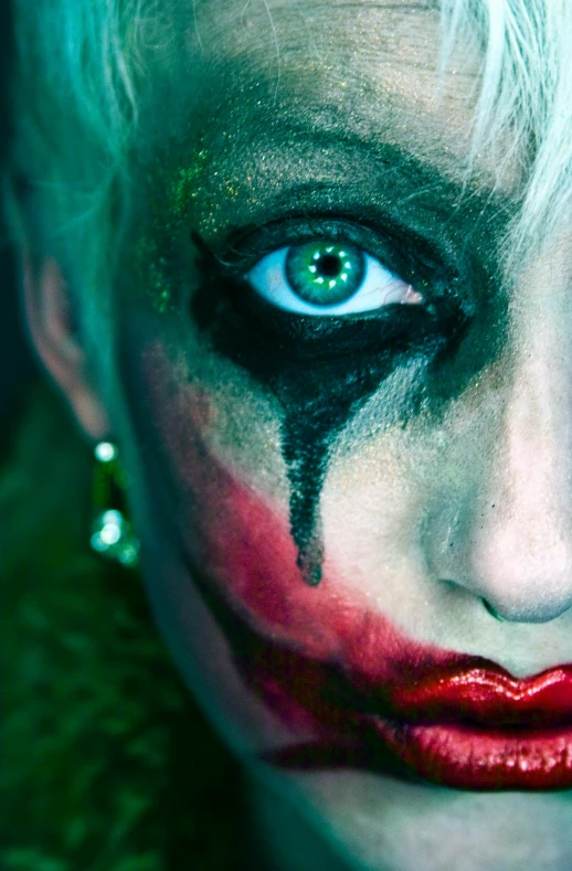 a close up of a person with makeup on, an album cover, by Thomas Bock, trending on pexels, scary clown, emerald coloured eyes, close up of a blonde woman, male jester