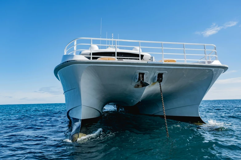 a large white boat in the middle of the ocean, view from ground level, luxury equipment, great barrier reef, leaking