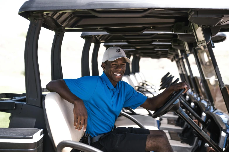 a man sitting in the driver's seat of a golf cart, a portrait, pexels contest winner, happening, brown skin man with a giant grin, thumbnail, working hard, high resolution photo